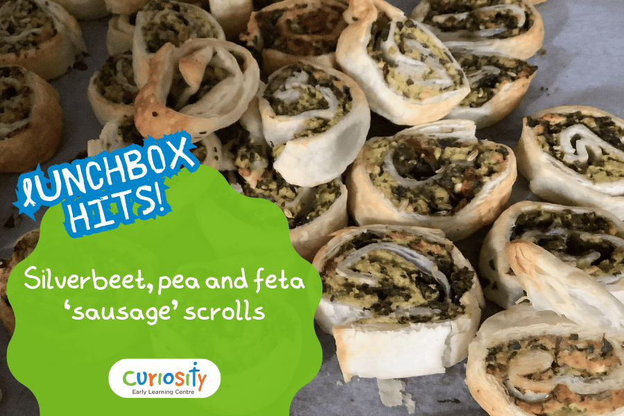 Title image of pastry scrolls with silverbeet, pea and feta. Text reads 'Lunchbox Hits! Silverbeet, pea and feta 'sausage' scrolls'.