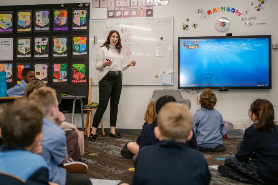 A teacher is instructing a class of students.