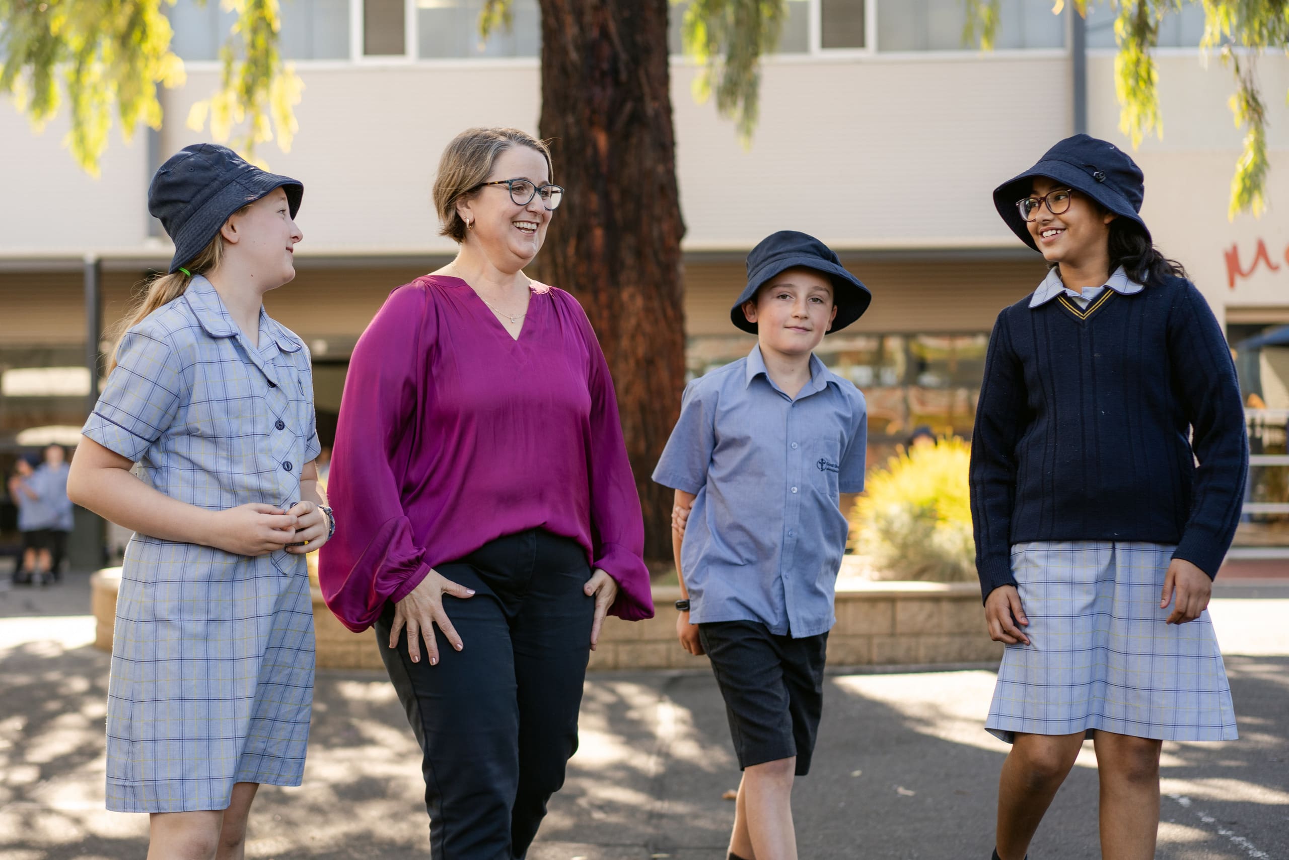 Principal Evie Stevens and students of Good Shepherd Lutheran School Para Vista walking together.