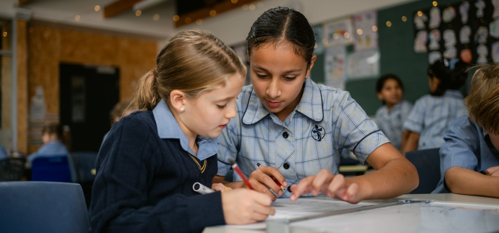 Two students are at a desk studying.